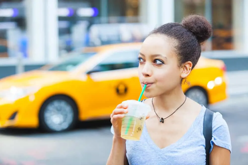 A beautiful black girl with red hair color uses chemical-free hair products to avoid allergic reactions.