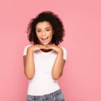 A black woman styled her curly hair with old argan oil and other expired hair products.