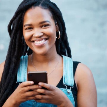 A black woman with long hair wearing adult-stage instant locs with minimal-frizz on her 4C hair type.