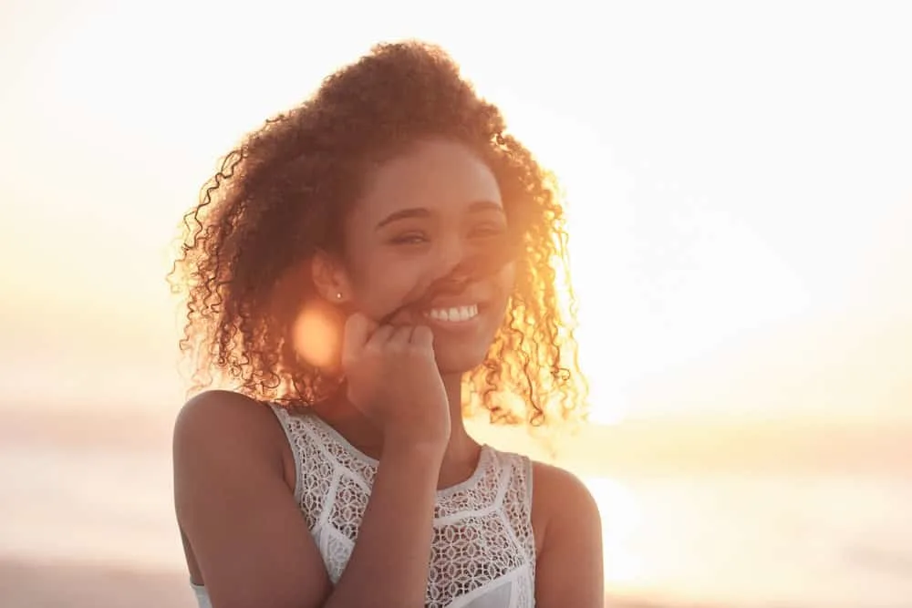 A beautiful black girl that eats a healthy diet to treat hair breakage and reduce hair fall.