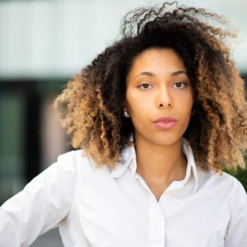 A cute black girl that used Shikakai for hair growth, hair lice, and to soothe her itchy scalp.