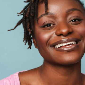 A black female with 4B natural hair wearing her healthy hair in braid locs styled with a palm rolling technique.