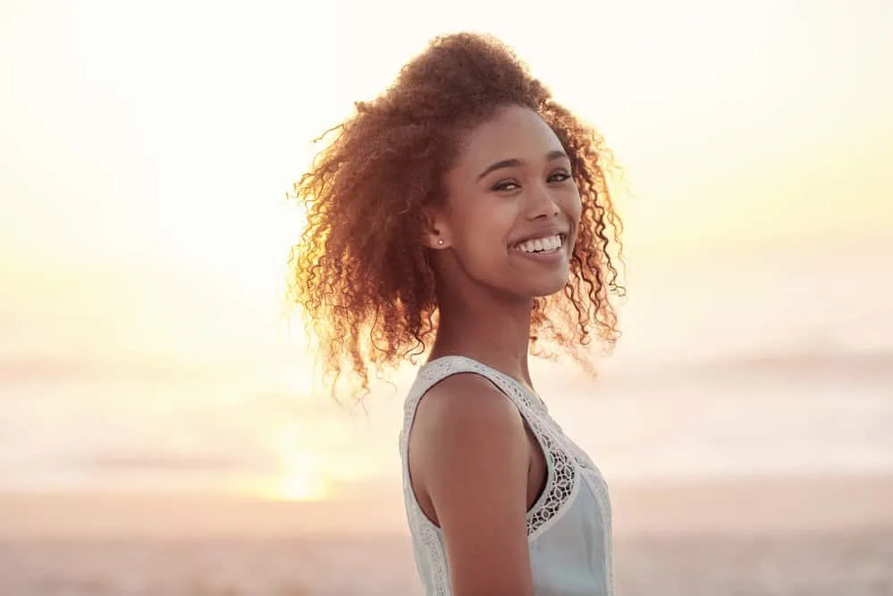 A light-skinned black woman that wore tight hairstyles, causing breakage.