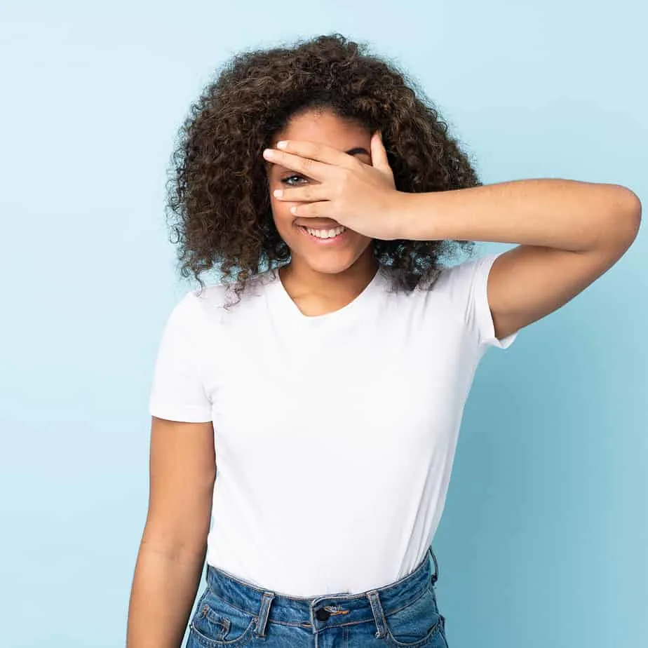 A beautiful African American female uses essential oils to encourage hair regrowth.