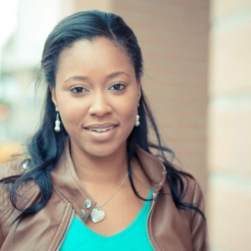 A beautiful African American woman with dark brown natural hair in a perfectly straight style after using a curly hair straightener on freshly washed hair.