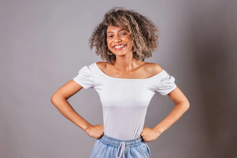 With wet hair, she rinses her scalp with an apple cider vinegar rinse, promoting scalp health and reducing hair fall.