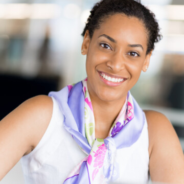 A young black woman with beautiful curls has been experiencing hair growth by using a simple hair care regimen with aloe vera gel, hair wax, and natural oils (e.g., coconut oil).