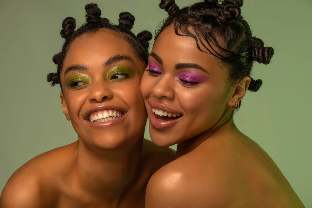 Two beautiful black girls converted their two-strand twist hairstyle into small knots. 