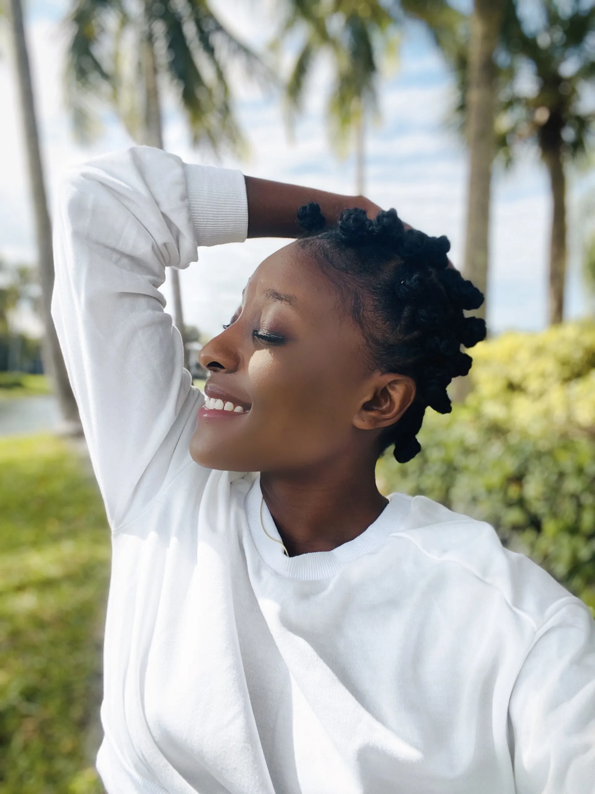 African American female wearing a freshly done traditional Banut knots. 